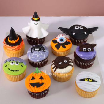 a group of halloween cupcakes with decorations