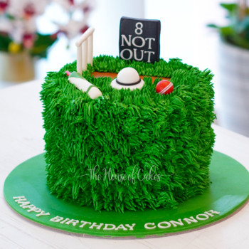 Custom-designed Cricket Cake showcasing intricate details of a cricket bat, ball, and a lush green field, expertly crafted by The House of Cakes Bakery in Dubai. A delightful masterpiece capturing the essence of the cricketing world, perfect for sports enthusiasts and cricket fans' celebrations.