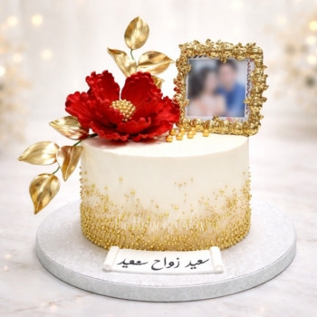 Cake with red flower, gold accents and photo frame