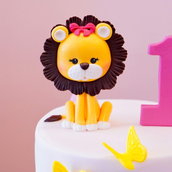 a cake with a lion figure and a number one