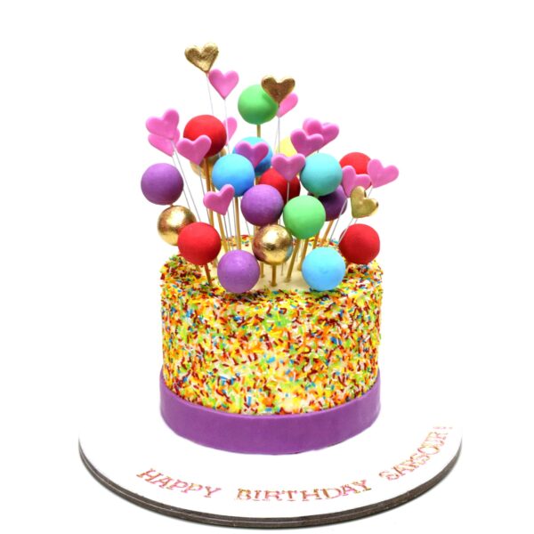 Cake with rainbow vermicelli balls and hearts