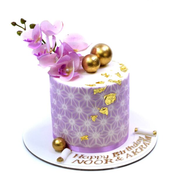 Cake with lilac orchids and edible gold details