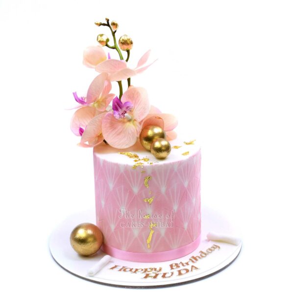Pretty pink cake with orchids and golden balls