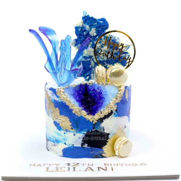 Blue geode cake with sugar sail and topper