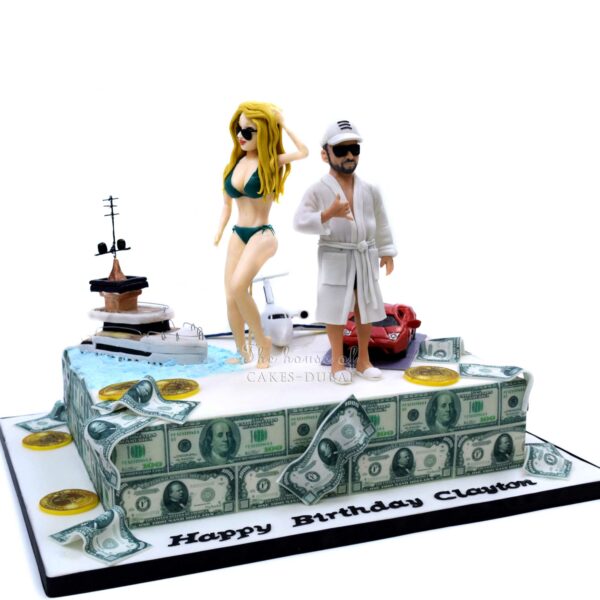 Customised cake with lady, man, yacht, plane, money and car