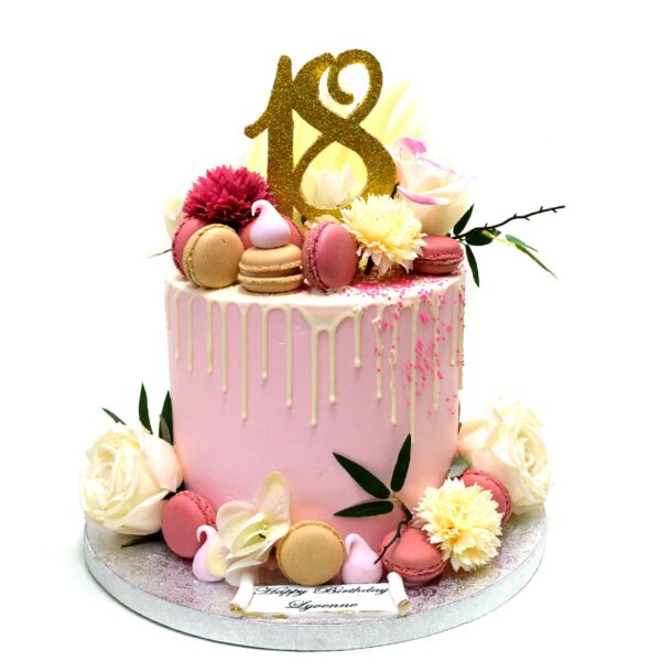 Dripping cake with macarons and flowers