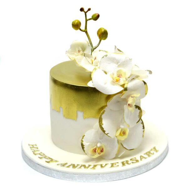 White and gold cake with orchids
