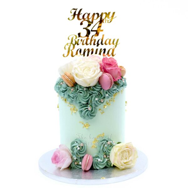 Light green cake with macarons and flowers