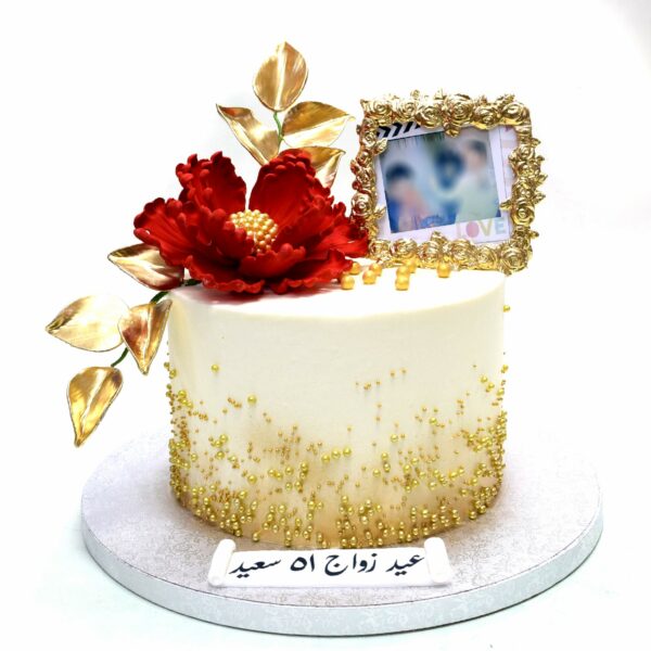 Cake with red flower, gold accents and photo frame