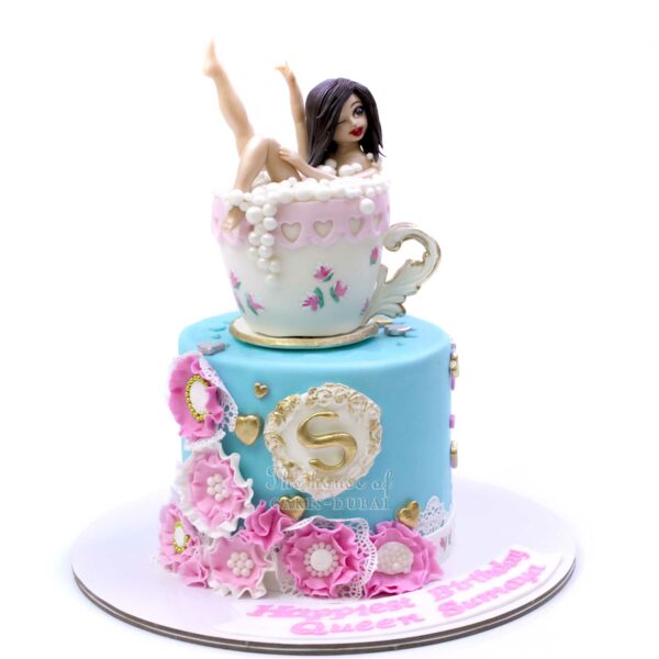 Pretty lady in tea cup cake