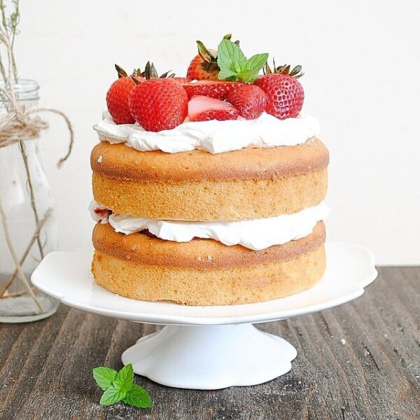 Naked cake with cream and strawberries