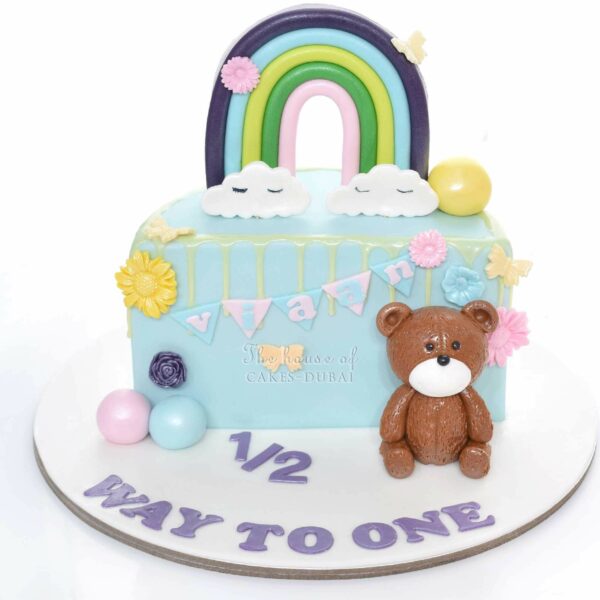 Half birthday cake with bear and rainbow