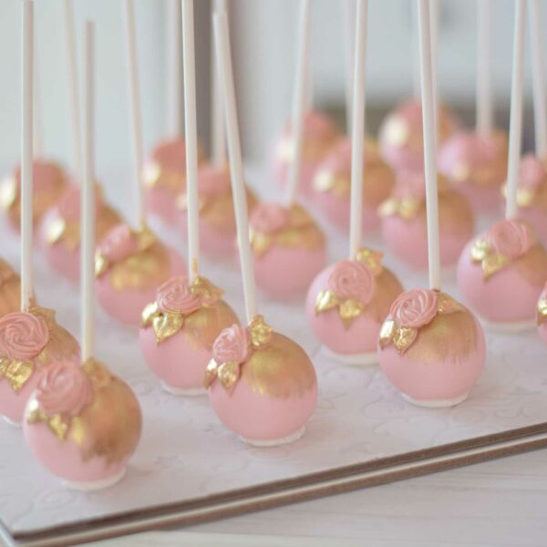 Pink and gold cake pops with flowers