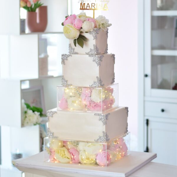Elegant cake with acrylic boxes, lights and flowers