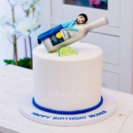 a cake with a guy and corona beer on top