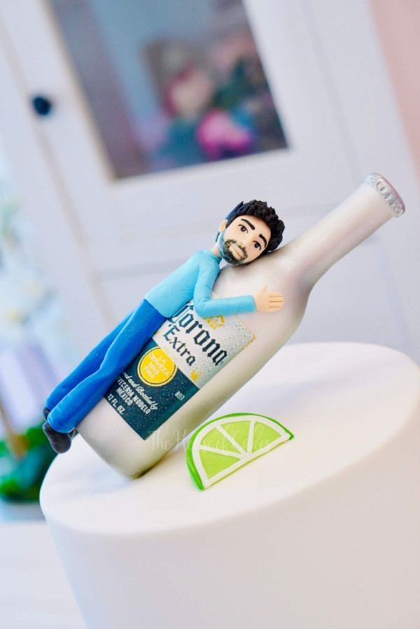 a figurine of a man hugging a beer bottle