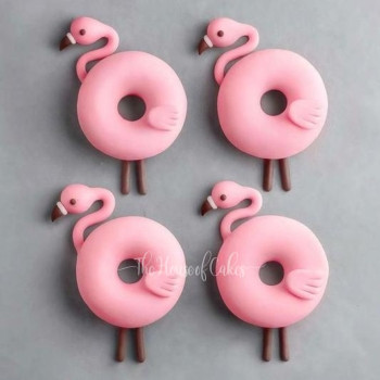 a group of pink donuts shaped as flamingo