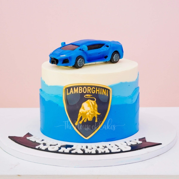 a blue cake with a lamborghni car on top