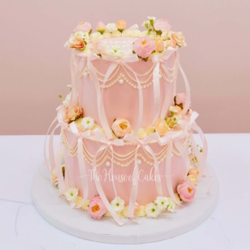 exquisite pink cake with ribbons and flowers